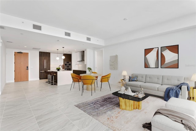 living area with recessed lighting and visible vents