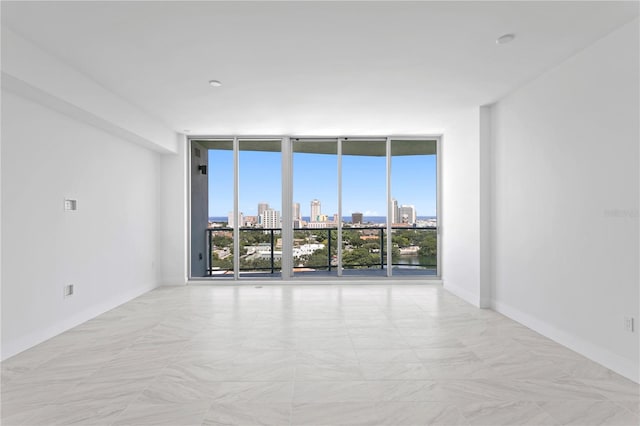 unfurnished room featuring floor to ceiling windows