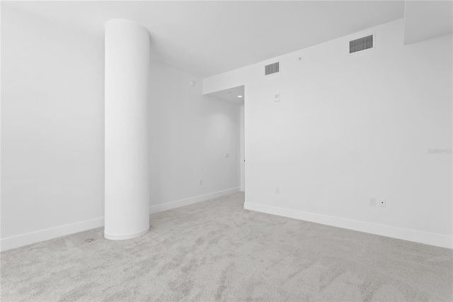 empty room featuring carpet flooring, baseboards, and visible vents