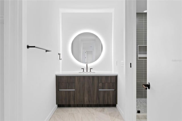 full bathroom featuring baseboards and vanity