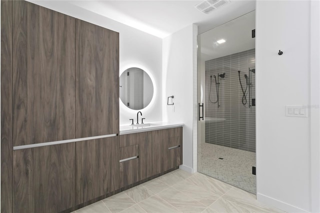 full bath featuring vanity, a shower stall, and visible vents