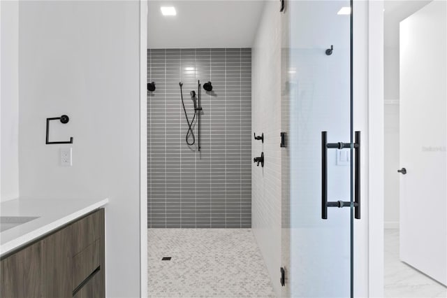 bathroom featuring vanity and an enclosed shower