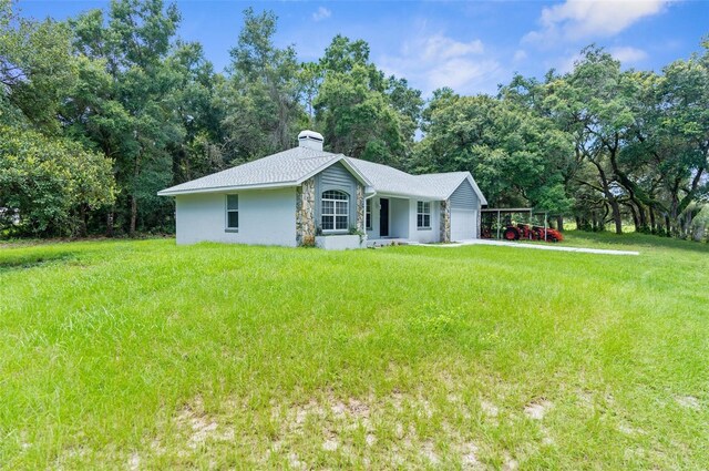 ranch-style home featuring a garage and a front yard