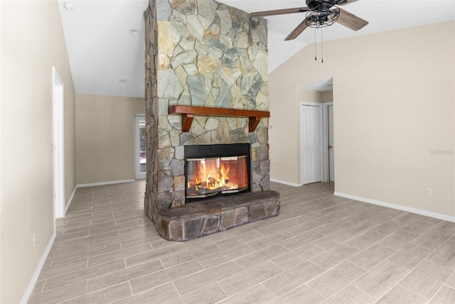 unfurnished living room with a stone fireplace, lofted ceiling, and ceiling fan