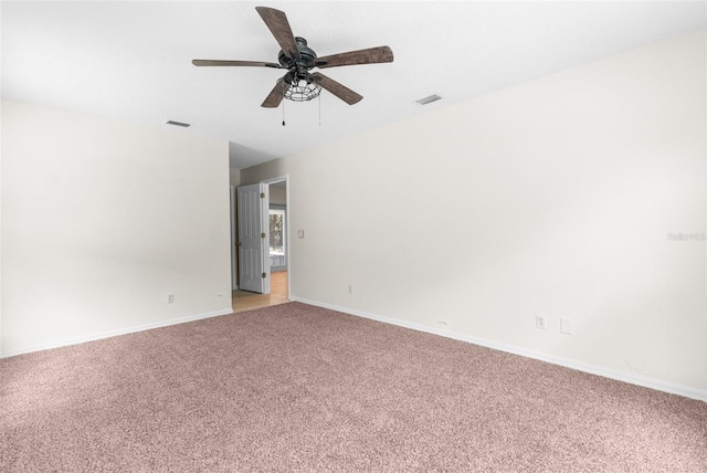 carpeted spare room featuring ceiling fan