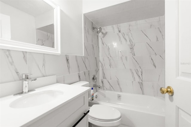 full bathroom with vanity, tiled shower / bath, tile walls, and toilet