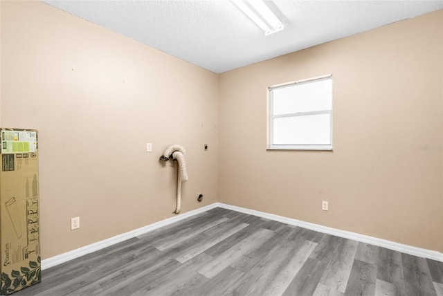 laundry area featuring a textured ceiling, wood-type flooring, and electric dryer hookup