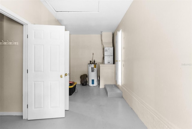 corridor featuring concrete flooring and water heater