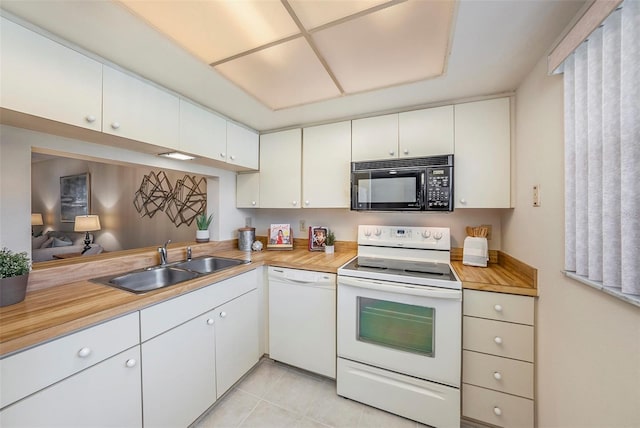 kitchen featuring white cabinetry, sink, white appliances, and wooden counters