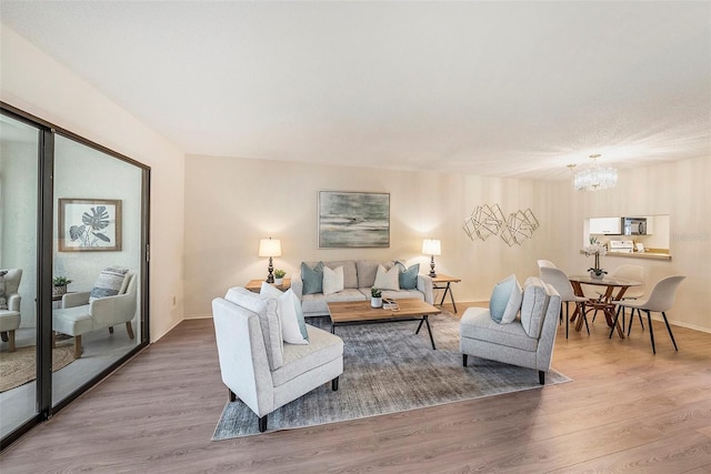 living room with wood-type flooring and an inviting chandelier