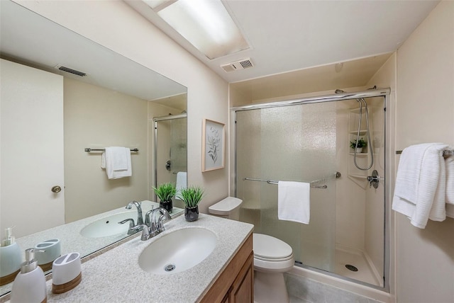 bathroom with tile patterned flooring, vanity, toilet, and walk in shower