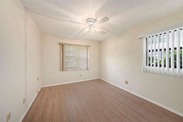 unfurnished room with hardwood / wood-style floors, a textured ceiling, and ceiling fan