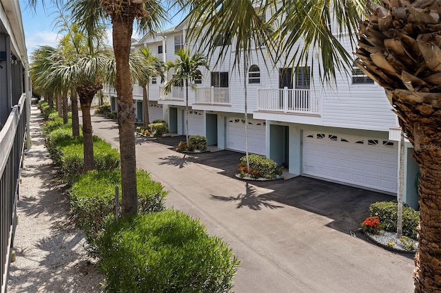 view of front facade featuring a balcony and a garage