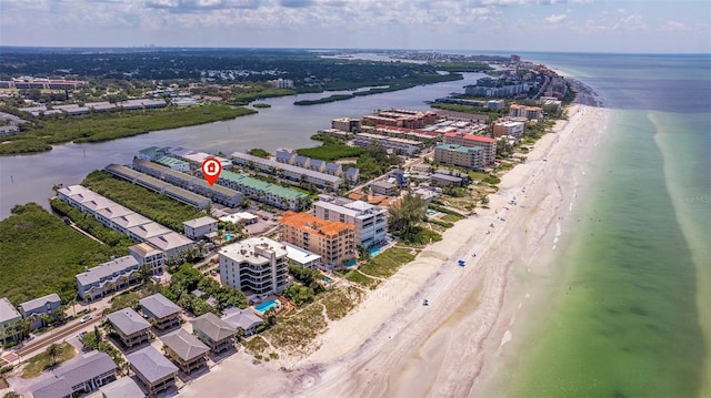 drone / aerial view with a water view and a beach view