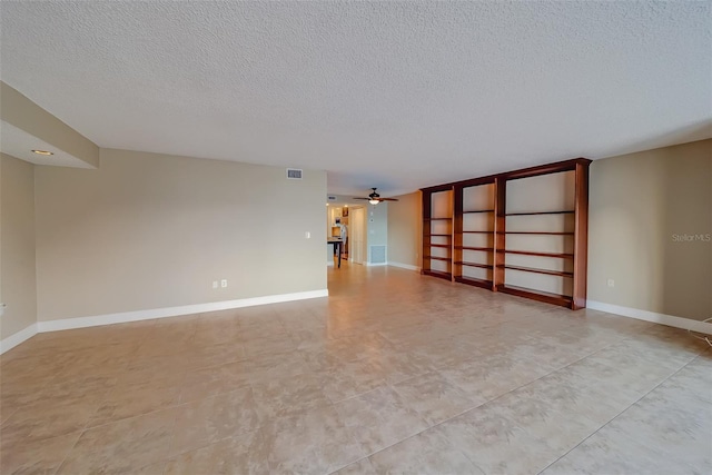 spare room with ceiling fan and a textured ceiling