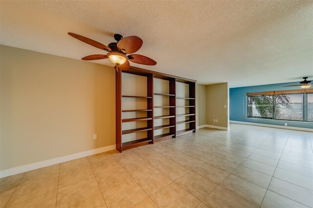 tiled spare room featuring ceiling fan and a textured ceiling