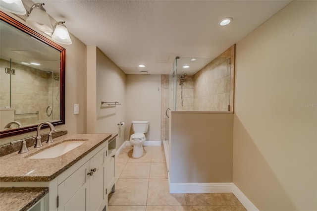 bathroom with tile patterned flooring, vanity, toilet, and a shower with shower door