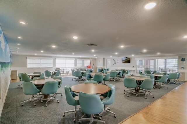 dining area with a textured ceiling and light wood-type flooring