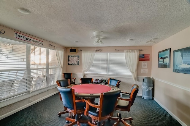 recreation room featuring carpet flooring and a textured ceiling