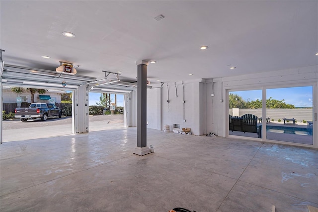 garage with recessed lighting and a garage door opener