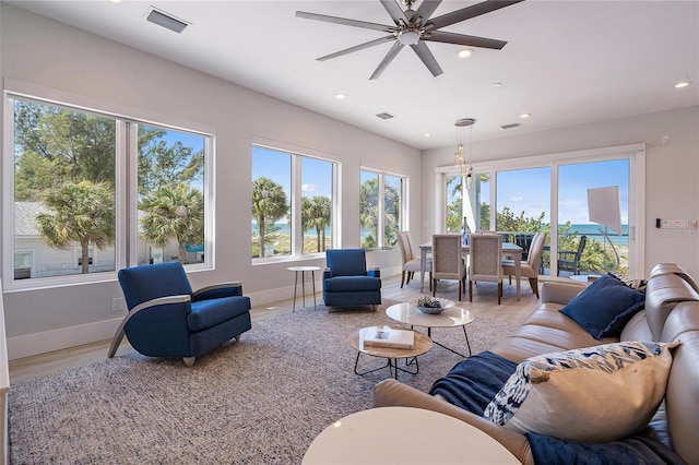 living room with hardwood / wood-style floors, a wealth of natural light, and ceiling fan