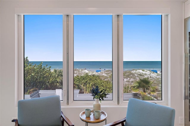 interior space featuring a beach view and a water view