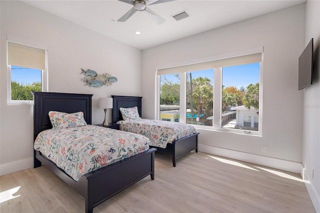 bedroom with light wood-type flooring and ceiling fan