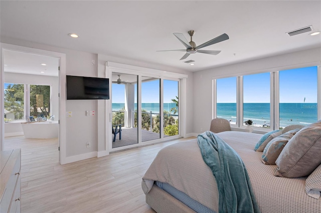 bedroom with multiple windows, access to exterior, light hardwood / wood-style flooring, and ceiling fan