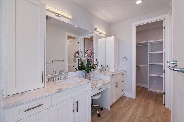 bathroom with hardwood / wood-style flooring and vanity