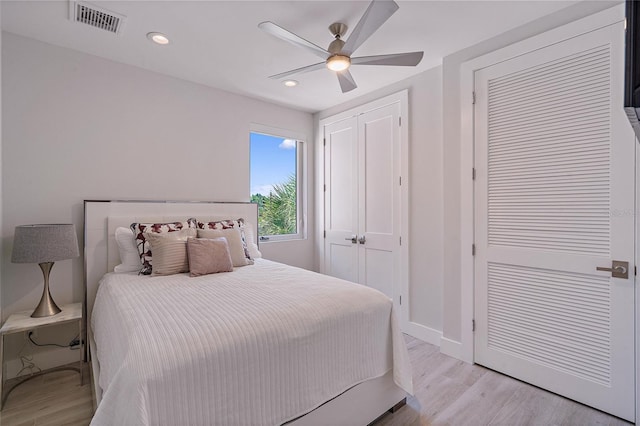 bedroom with ceiling fan and light hardwood / wood-style floors