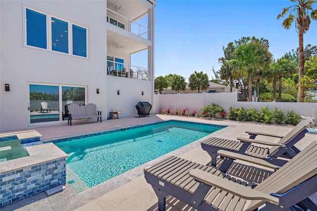 view of pool with grilling area, ceiling fan, and a patio area