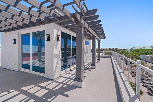 view of patio with a pergola and a balcony