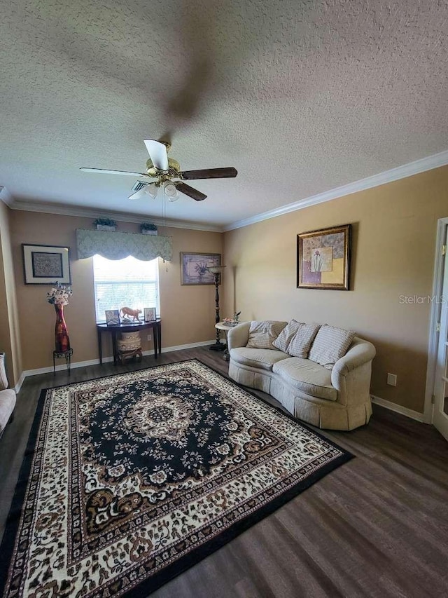 living room featuring baseboards, ceiling fan, ornamental molding, wood finished floors, and a textured ceiling