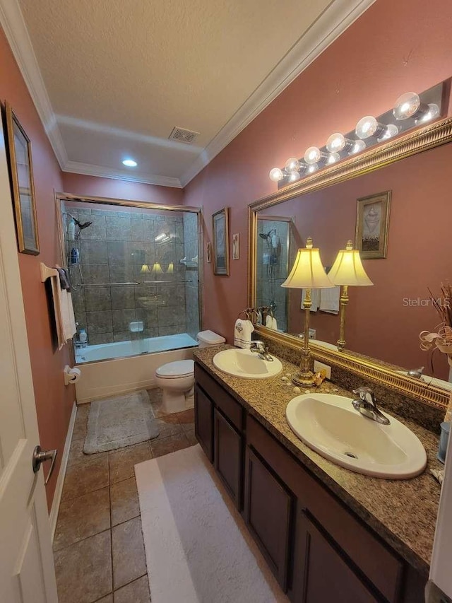 full bathroom featuring toilet, tile patterned flooring, vanity, a textured ceiling, and bath / shower combo with glass door