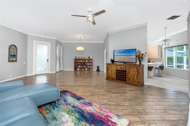 tiled living room featuring ceiling fan and crown molding