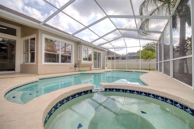 view of swimming pool featuring a patio, a lanai, and an in ground hot tub