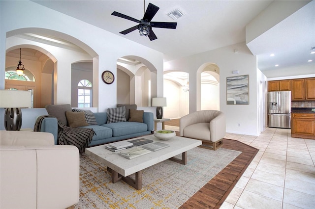 living room with light wood-type flooring and ceiling fan