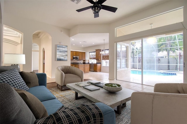 living room with light hardwood / wood-style flooring and ceiling fan with notable chandelier