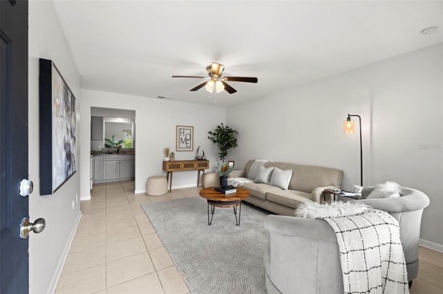 living room with ceiling fan and light tile patterned floors