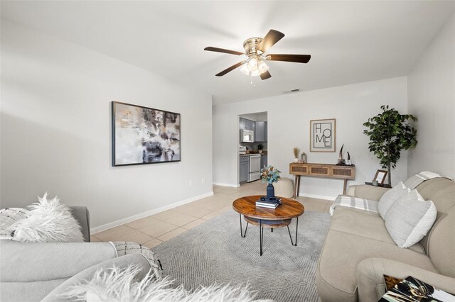 living room featuring ceiling fan and light tile patterned floors