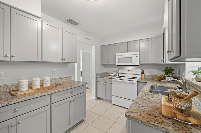 kitchen featuring white appliances, gray cabinetry, and sink