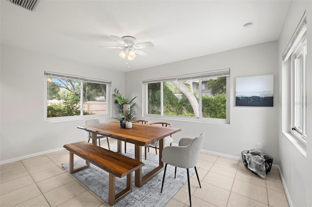 tiled dining area featuring ceiling fan