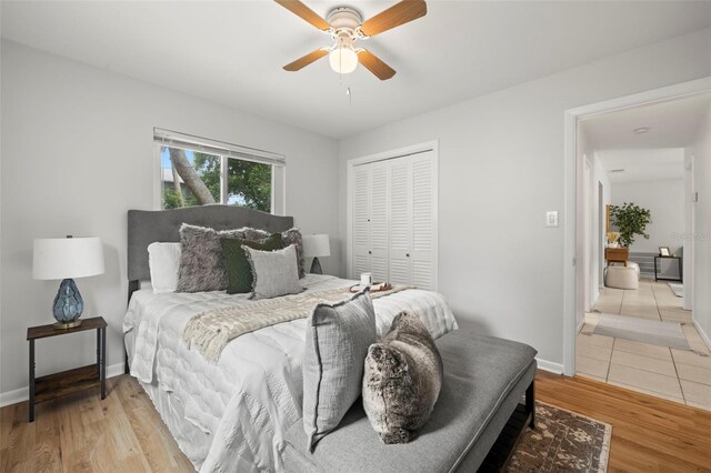 bedroom featuring light wood-type flooring, a closet, and ceiling fan