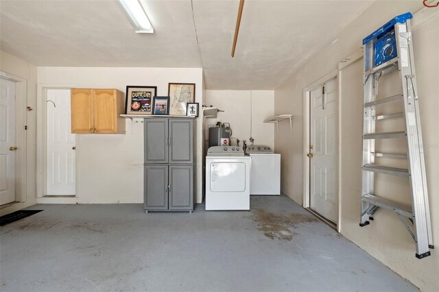 interior space with washing machine and dryer and water heater