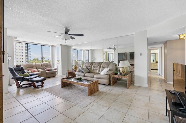 tiled living room with a textured ceiling, ceiling fan, and floor to ceiling windows