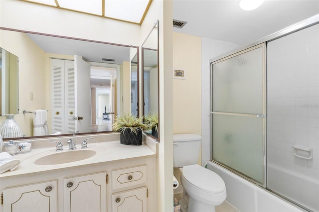 full bathroom with toilet, vanity, and combined bath / shower with glass door