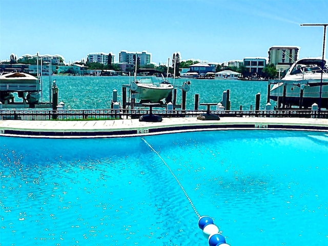 view of swimming pool featuring a boat dock