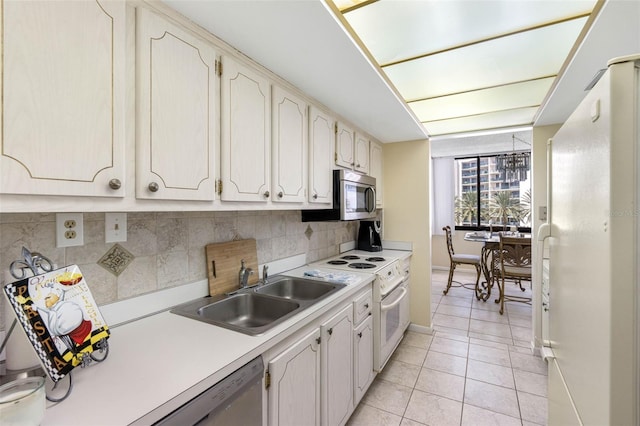 kitchen with white appliances, light tile patterned floors, tasteful backsplash, and sink