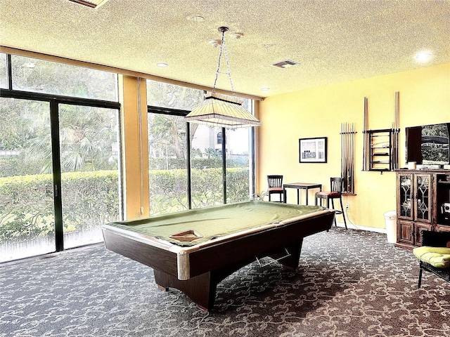 recreation room featuring billiards, a textured ceiling, and dark colored carpet