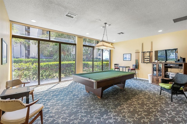 game room with floor to ceiling windows, dark carpet, a textured ceiling, and billiards